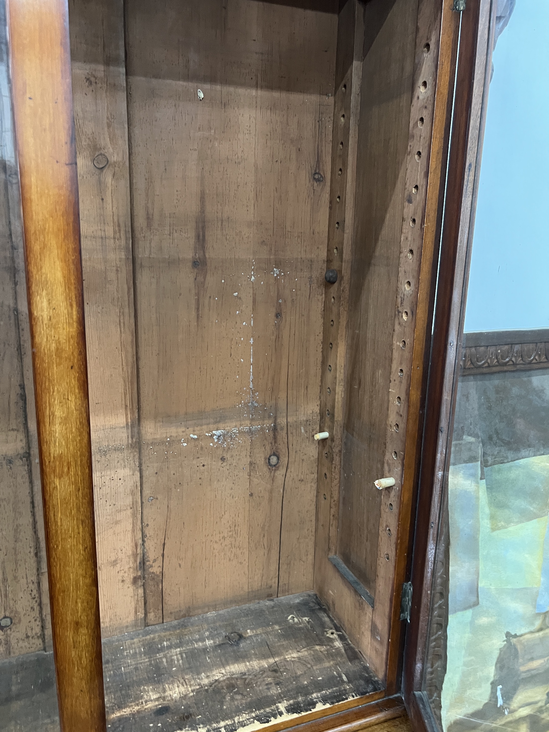 A Victorian serpentine mahogany bookcase cupboard, width 88cm, depth 48cm, height 205cm